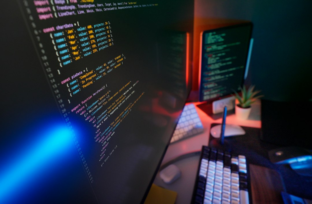 Software development workspace with code displayed on computer monitors